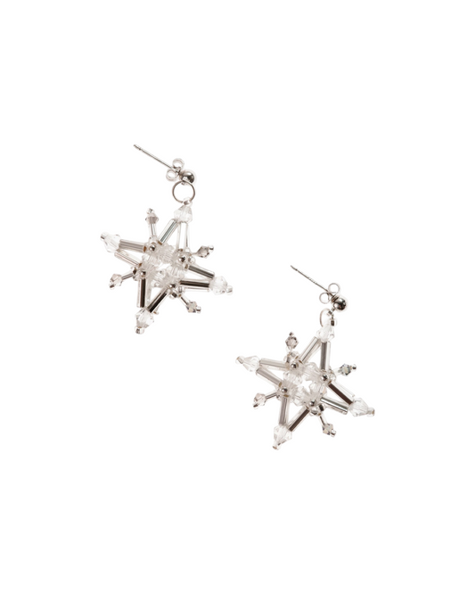 Silver-tone starburst crystal earrings with dangling hook and central clear gem