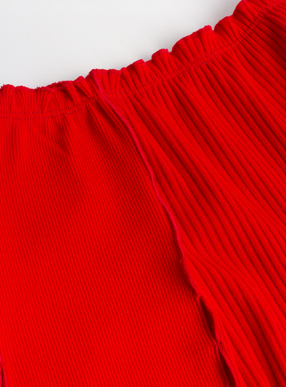 Red ribbed boyshorts close-up with elastic waistband and curved seam