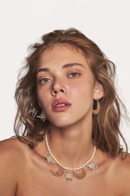 Pearl-bead necklace with star pendants and crescent crystal clusters at neckline
