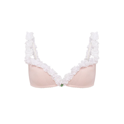 Pink ribbed bralette with white ruffle trim and small multicolor leaf detail at center