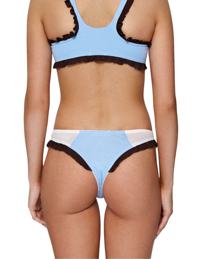 Light blue thong underwear with dark ruffle trim and white waistband, back view