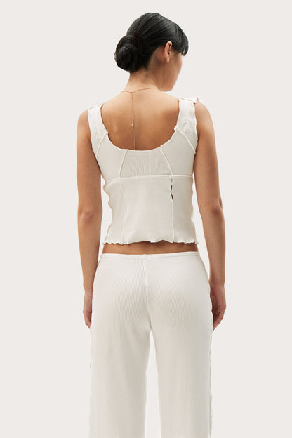 Back of white short tank with open neckline and vertical seam, sleeveless.