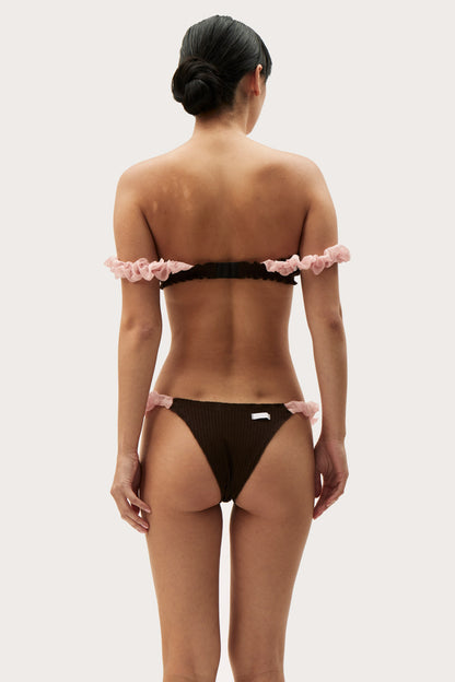 Back view: brown thong with pink ruffled waistband and leg openings