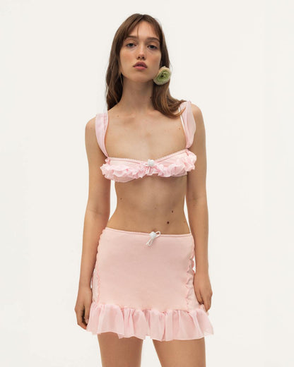 Pink skort with ruffled hem and bow-front waistband.